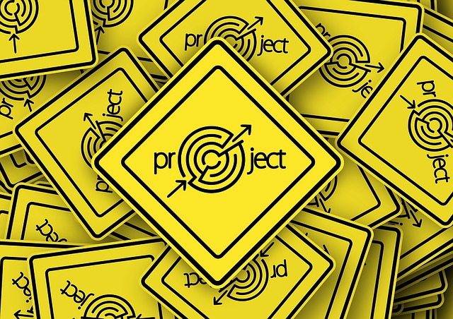 IPM103 Course Image: Pile of yellow warning signs with the word project where the letter O is replaced with a target
