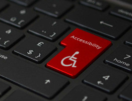 Closeup image of back notebook keyboard with the enter key replaced with a red accessibility key.